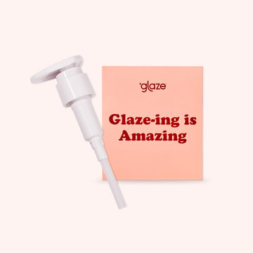 white pump bottle with a pink card displaying 'glaze-ing is amazing' on a white background